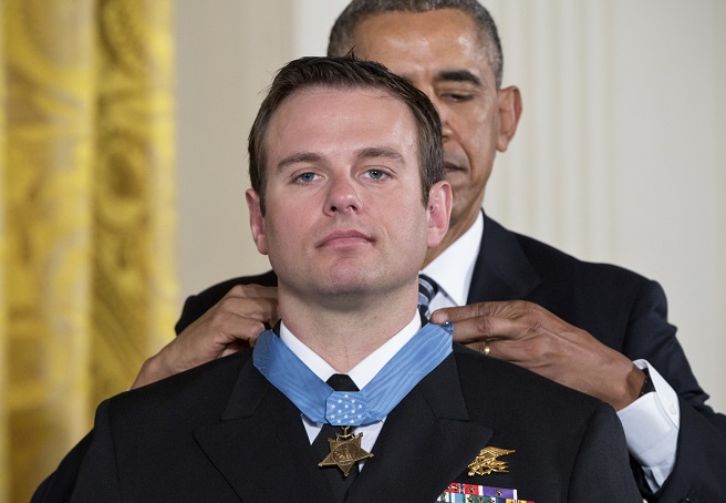 President Barack Obama presents the Medal of Honor to Senior Chief Special Warfare Operator Edward Byers during a ceremony in the East Room of the White House in Washington Monday