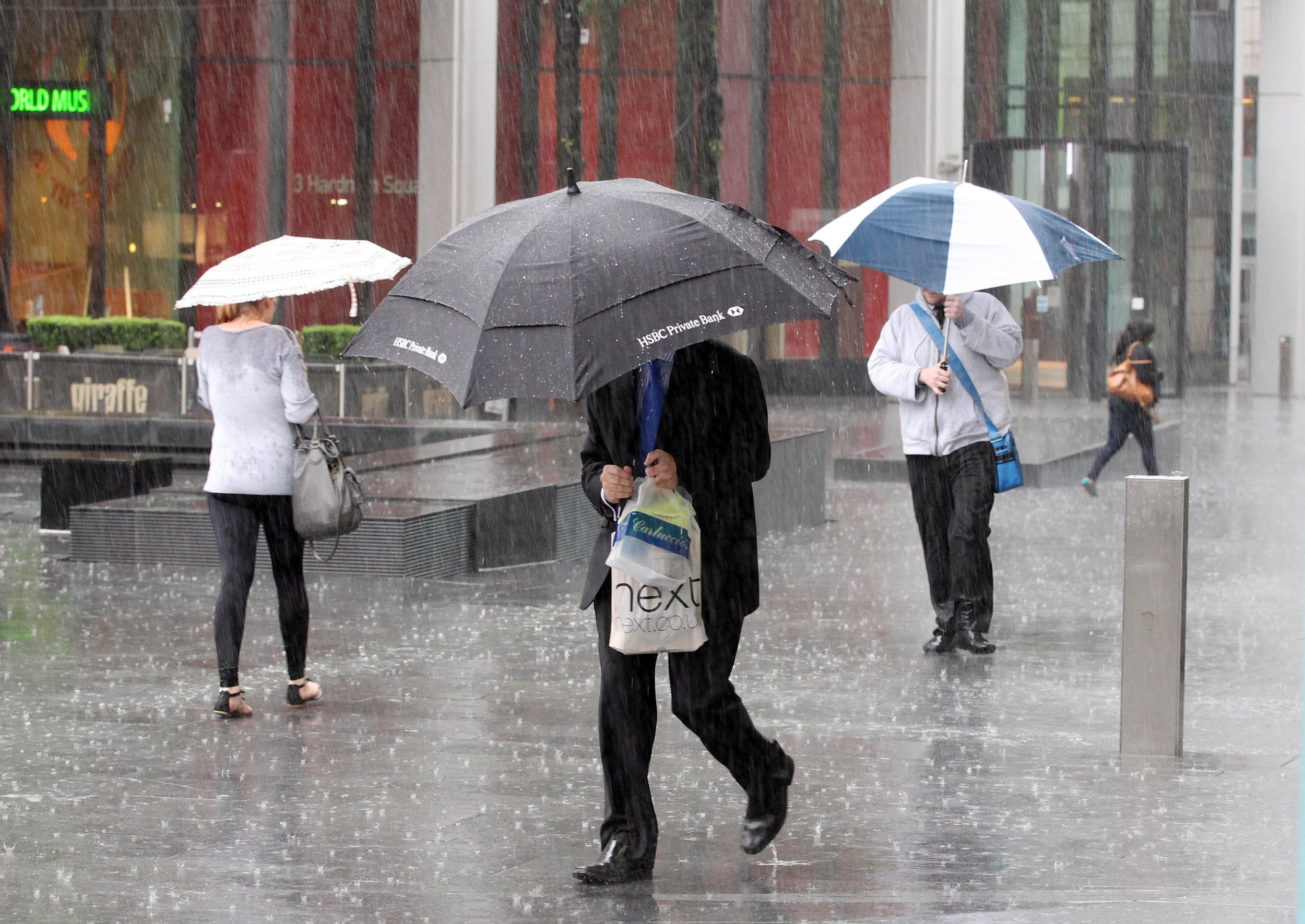 Torrential rain hits the Spinningfields area of Manchester on Wednesday afternoon