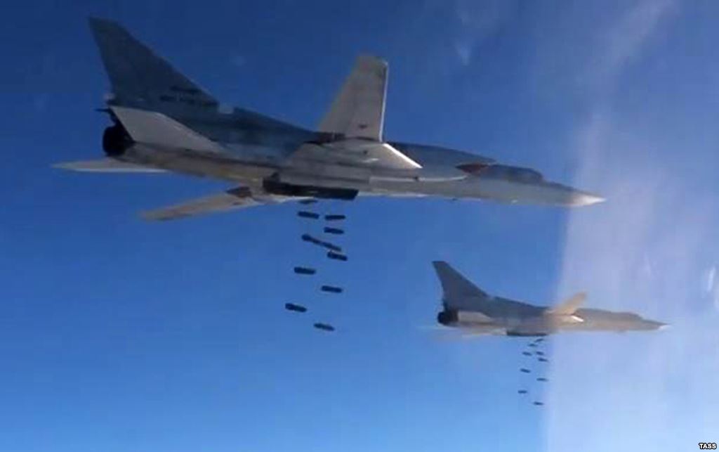 Russian Tupolev Tu-22 M3 strategic bombers drop bombs at an unknown location in Syria on November 18