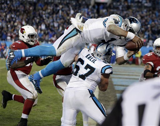 Carolina Panthers' Cam Newton leaps in the end zone for a touchdown run during the second half the NFL football NFC Championship game against the Arizona Cardinals Sunday in Charlotte N.C